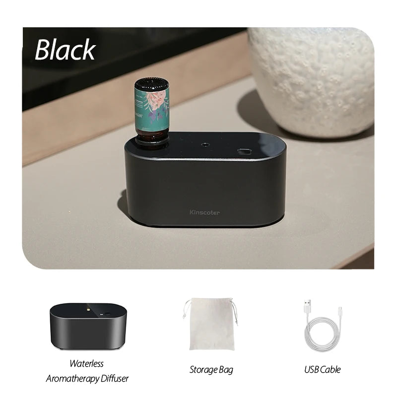Black KINSCOTER waterless aroma diffuser with essential oil bottle, storage bag, and USB cable on a sleek surface.