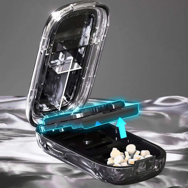 Black Adjustable Pill Cutter by e.chu, open with an arrow indicating the cutting action, showing pills in storage compartments.