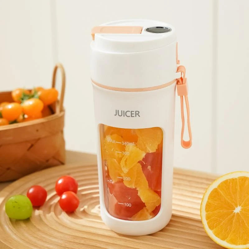 White juicer with orange and red fruits on a wooden surface