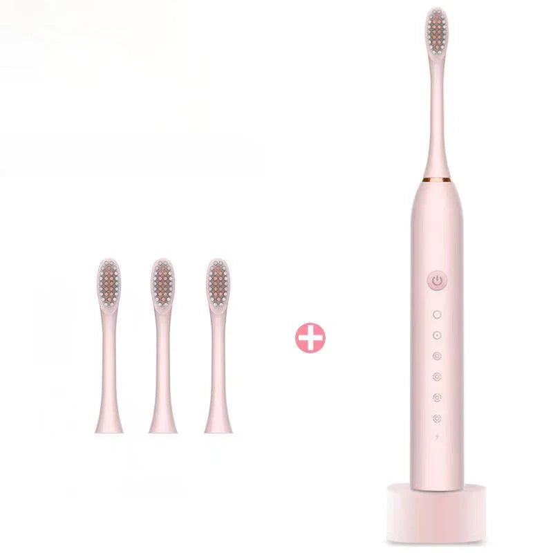 Pink electric toothbrush with three replacement brush heads and charging base