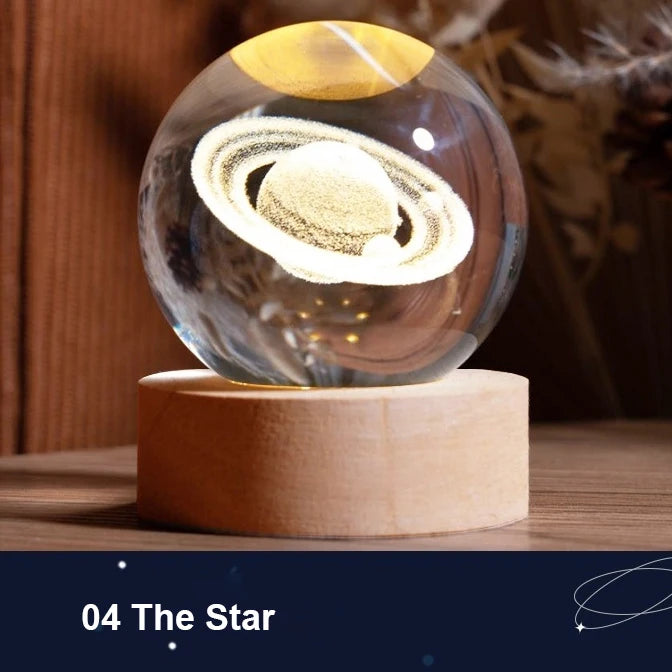 Glass sphere with planetary design on a wooden base, labeled '04 The Star'.