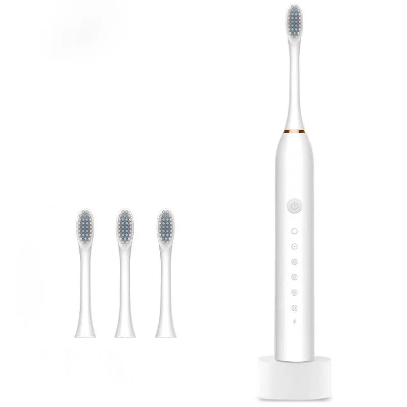 White electric toothbrush with three extra brush heads and charging base