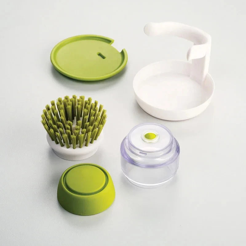 Set of kitchen cleaning tools including a brush, container, and lid on a light gray background