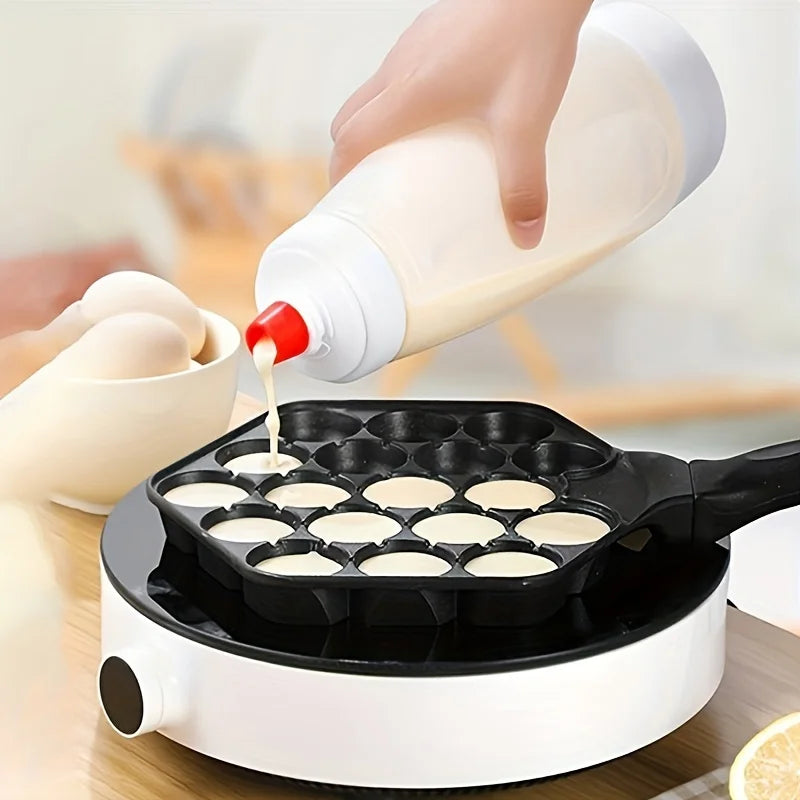 Hand pouring batter into mini waffle mold with pancake bottle dispenser