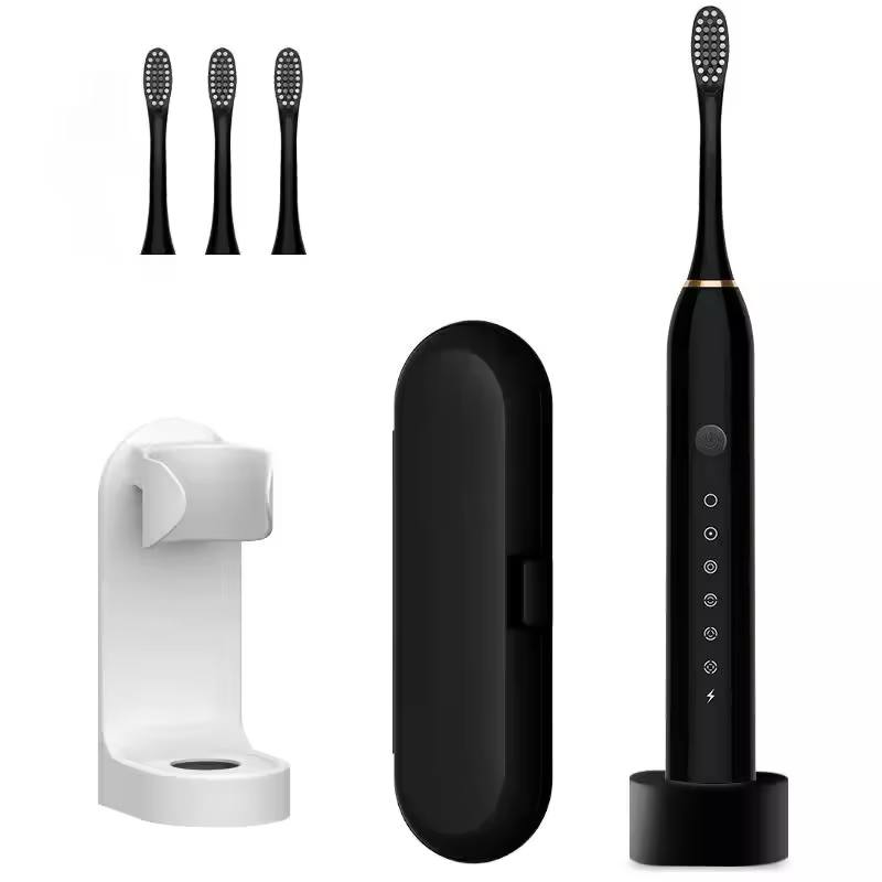 Black electric toothbrush kit with three brush heads and charging base