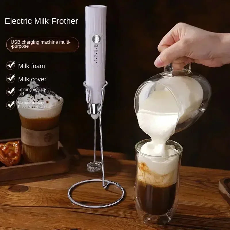 Electric milk frother creating creamy foam for coffee with stand and accessories