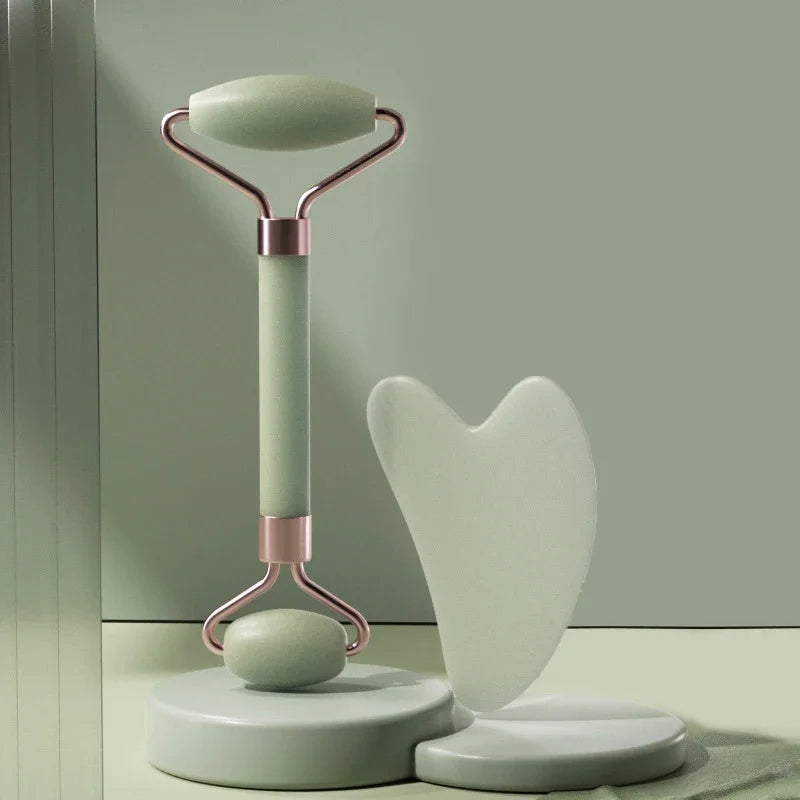 Green jade face roller and gua sha set on stand for relaxing facial massage and skincare routine