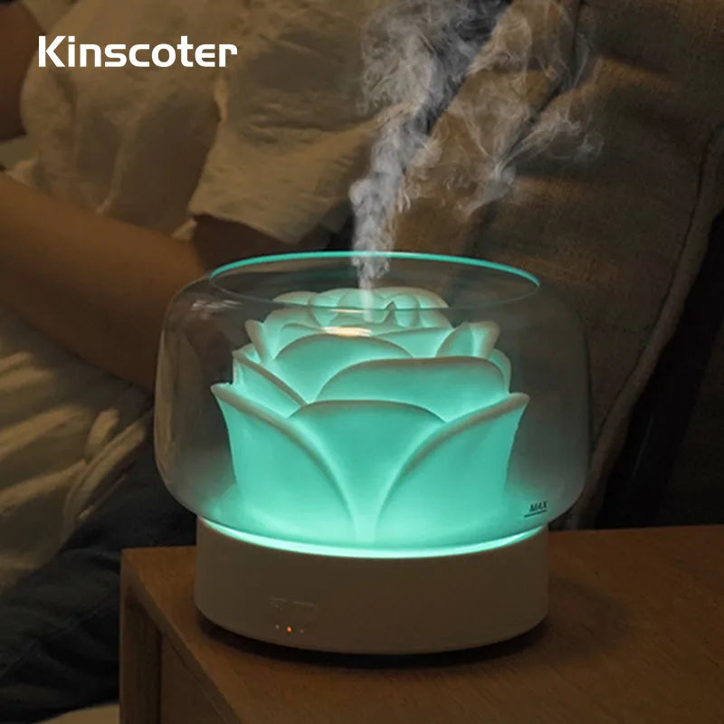 Aroma diffuser with glowing green light and essential oil mist.