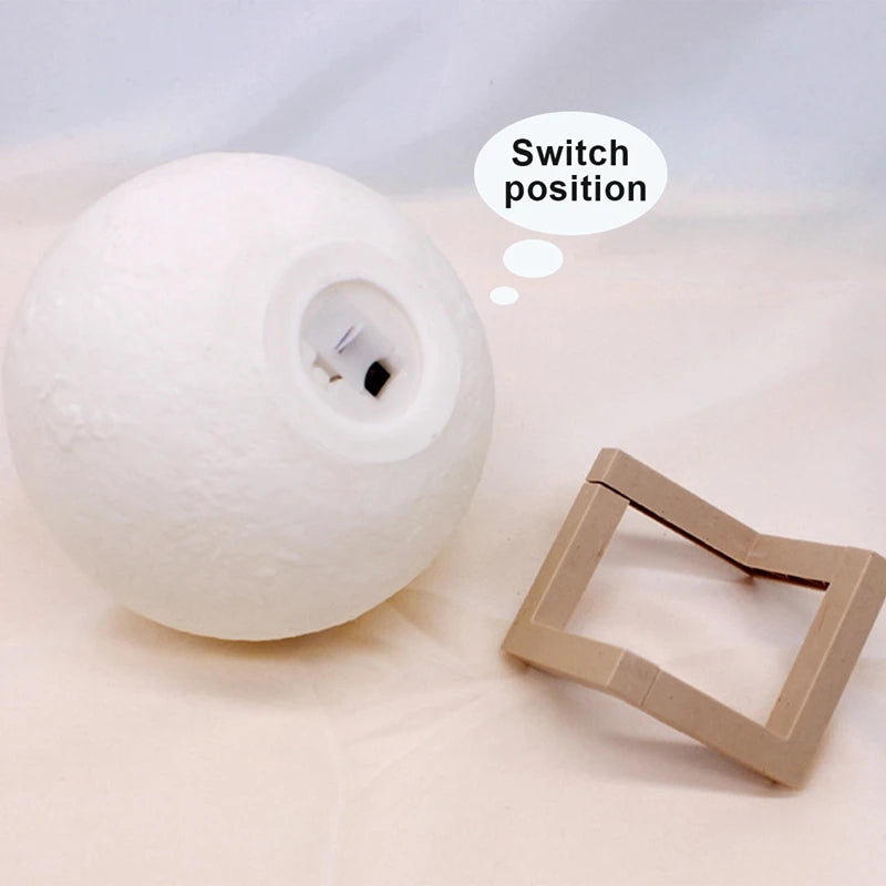 White spherical lamp with a cardboard square on a light gray background