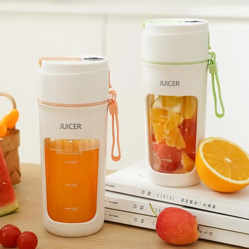 Two portable juicers with fruits and books on a wooden surface