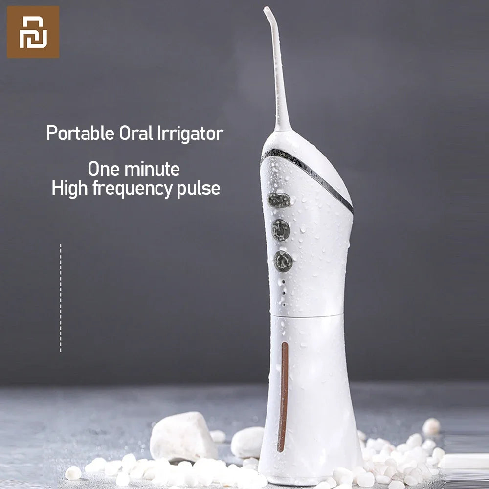 Portable oral irrigator with text on a dark background