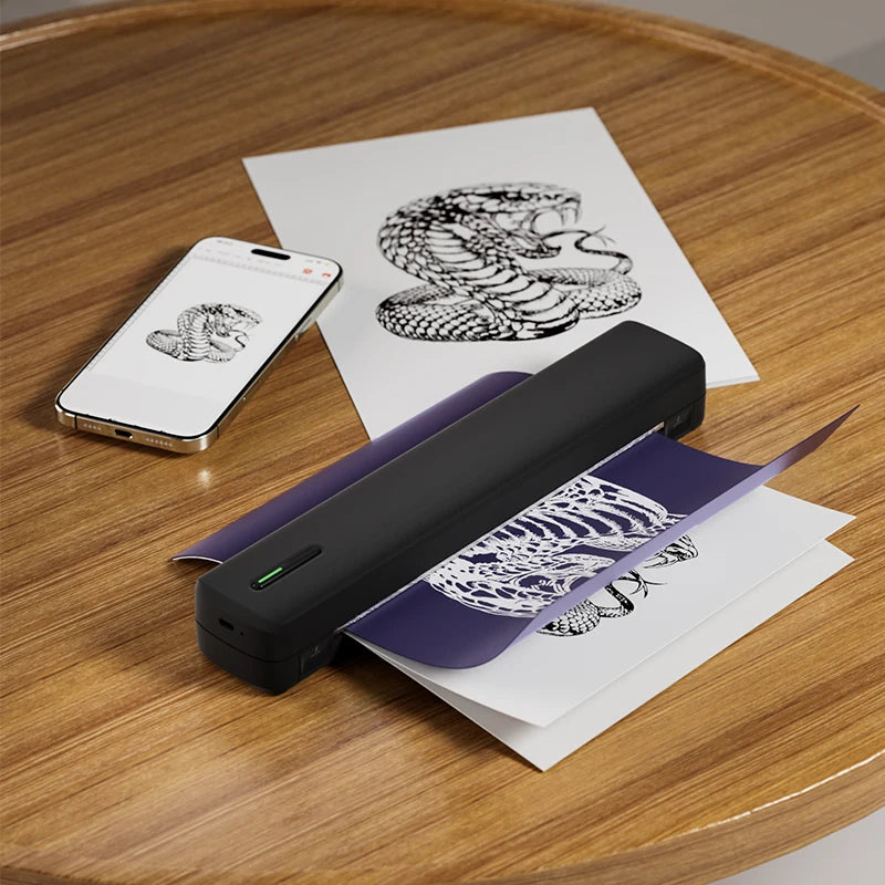 Portable tattoo stencil printer transferring snake design from phone